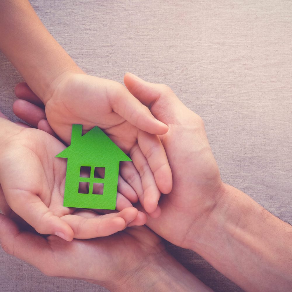 Adult,And,Child,Hands,Holding,Paper,Eco,House,,Family,Home,